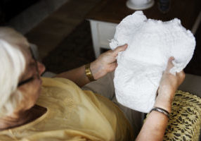 Senior woman looking at a diaper
